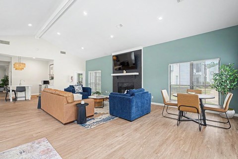 A living room with a blue sofa and a wooden floor.