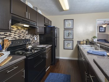 Kitchen appliances and cabinets at Harvard Place Apartment Homes by ICER, Lithonia, GA - Photo Gallery 54