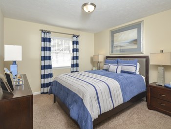 Bed with window view at Harvard Place Apartment Homes by ICER, Lithonia - Photo Gallery 57
