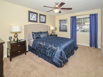 Bedroom with cozy bed and lights at Harvard Place Apartment Homes by ICER, Lithonia, 30058 - Photo Gallery 62