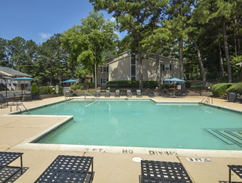 Daytime view pool with patio and sundeck at Harvard Place Apartment Homes by ICER, Lithonia, 30058 - Photo Gallery 97