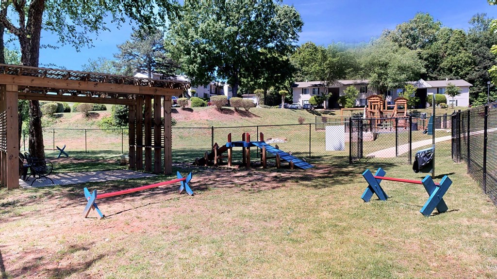 a playground with a wooden structure and a blue and red swing set  at Vue on Medlock, Georgia