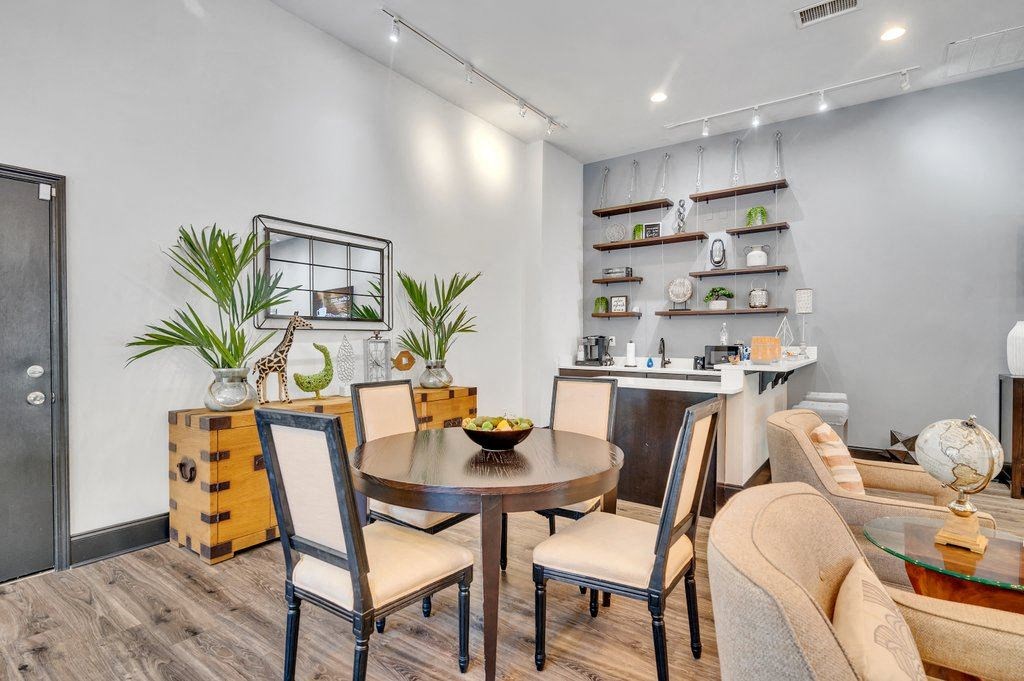 a dining room with a table and chairs and a kitchen