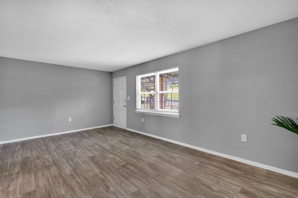 the living room of an empty house with a window