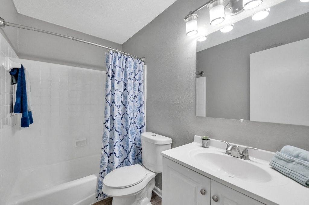 a bathroom with a sink toilet and a shower