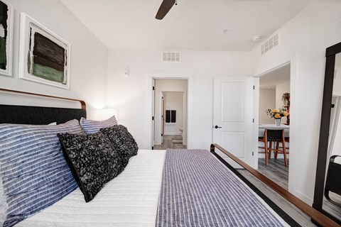 the master bedroom has a large bed and a view of the bathroom