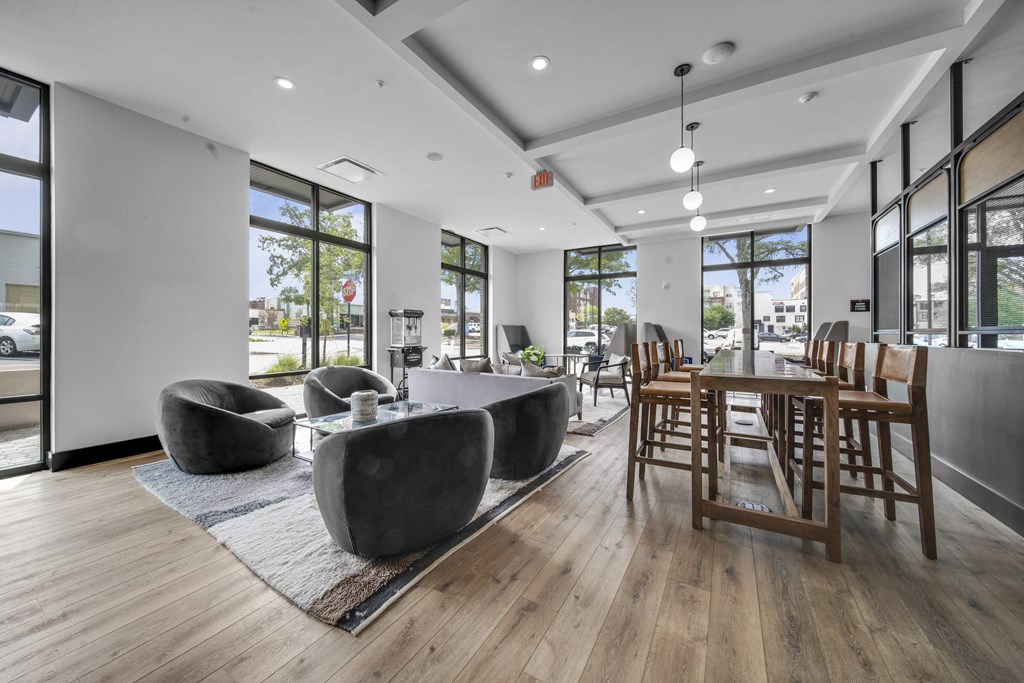 a living room with couches and chairs and a dining room table