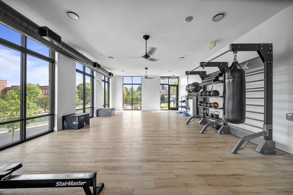 a workout room with weights and a large window