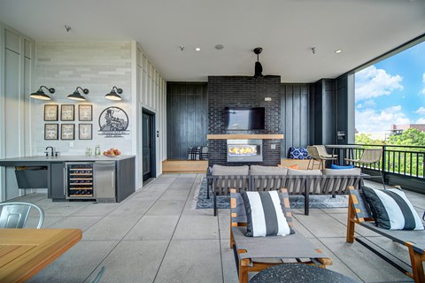 a living room with a fireplace and a table with chairs