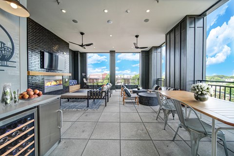 an open living room with tables and chairs and a fireplace