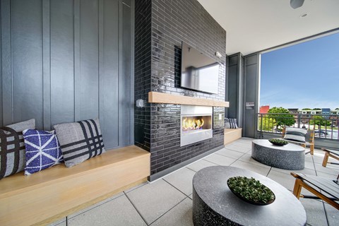 a living room with a fireplace and a balcony