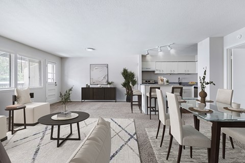 A modern dining room with a glass table and chairs.