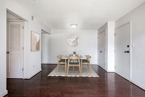 A dining room with a table set for two.