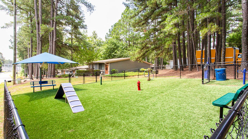 our apartments showcase a dog park with a kennel and agility course