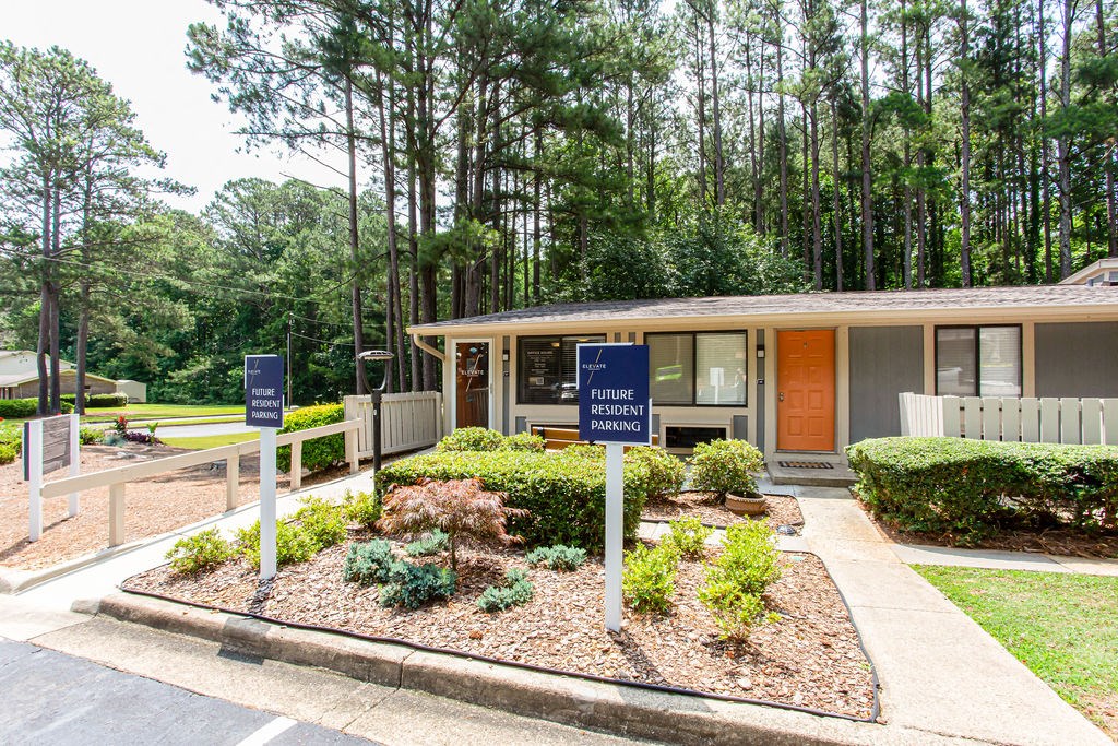 a small building with two signs in front of it