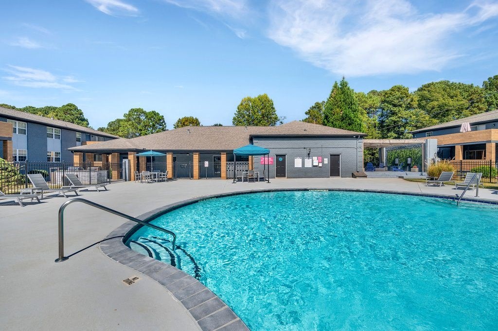 a resort style pool with a building in the background