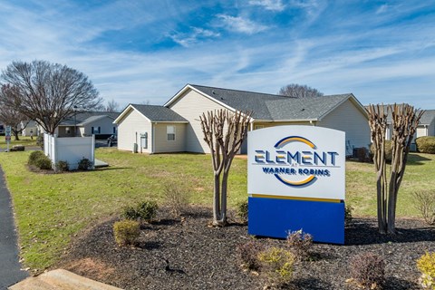 a sign in front of a house