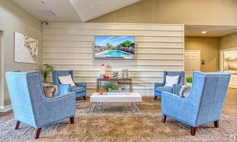 the preserve at ballantyne commons living room with blue chairs and a coffee table