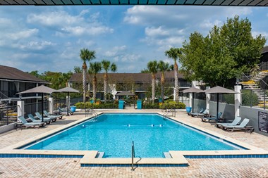 A spacious swimming pool with lounge chairs at the Essex apartment homes located at 112 Essex avenue, Altamonte Springs, FL 32701
