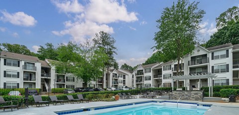 A swimming pool in front of apartment buildings.