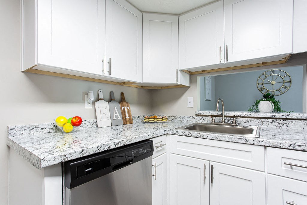 Kitchen with white cabinets and granite countertops at The Cobb Apartments-Townhomes, Austell, GA, Georgia, 30168