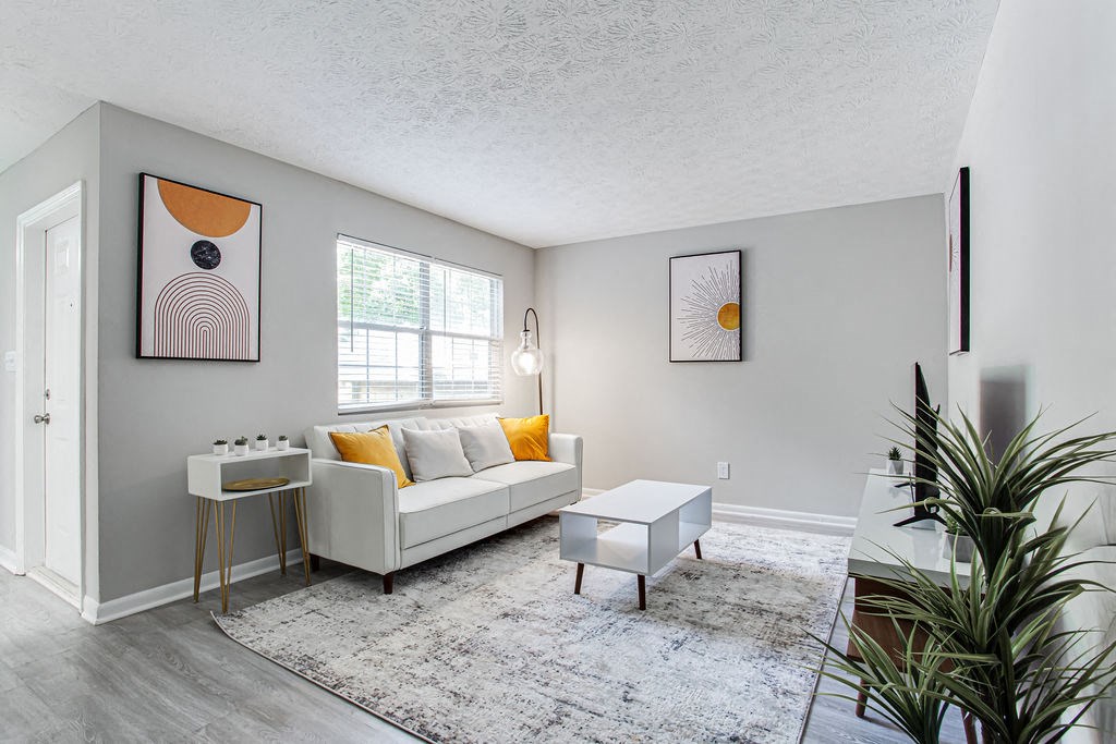 Living Space Plenty Of Natural Light at The Cobb Apartments-Townhomes, Austell