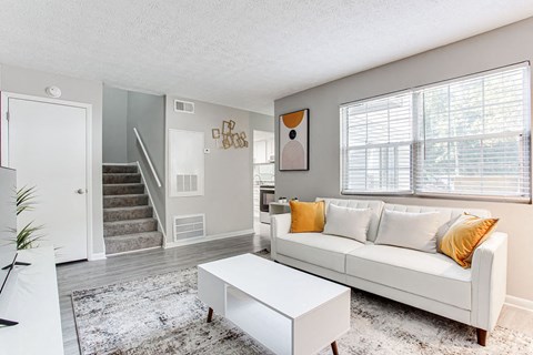 a living room with a white couch and a white coffee table