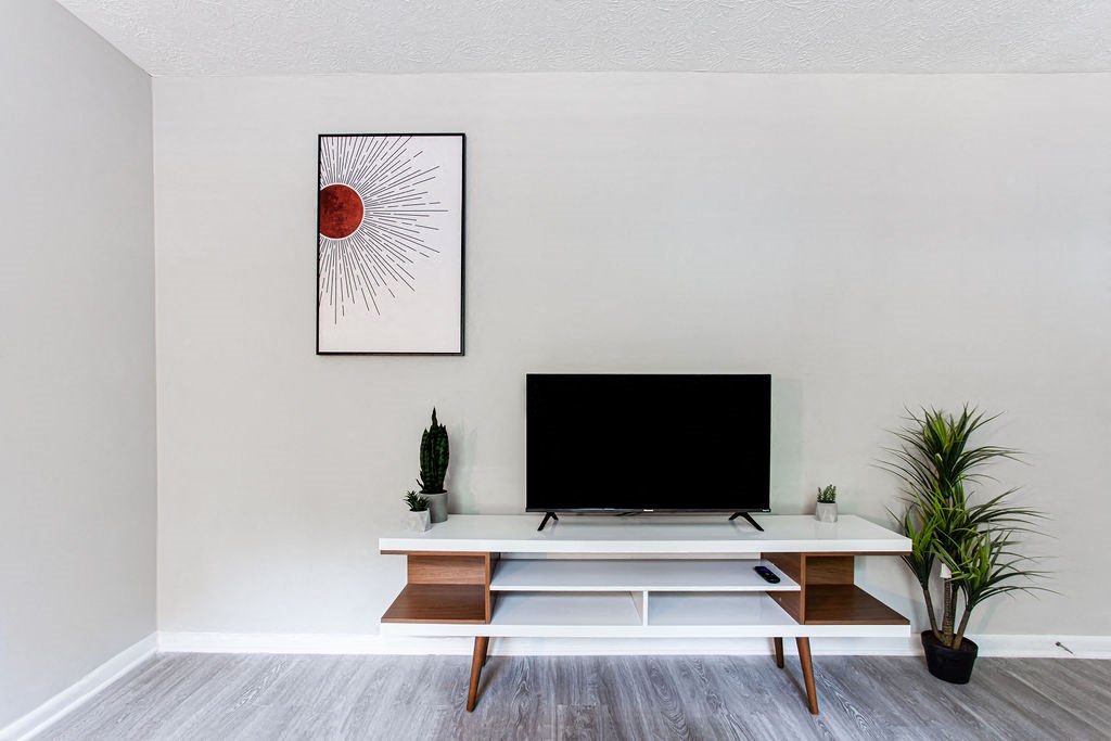 a living room with a tv at The Cobb Apartments-Townhomes, Austell, 30168