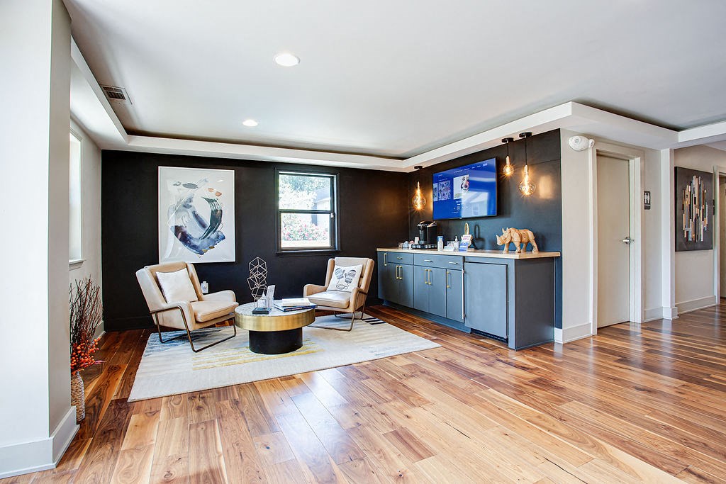 a living room with two chairs and a tv