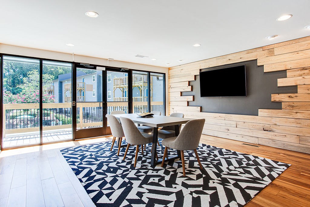 a dining room with a table and chairs and a television