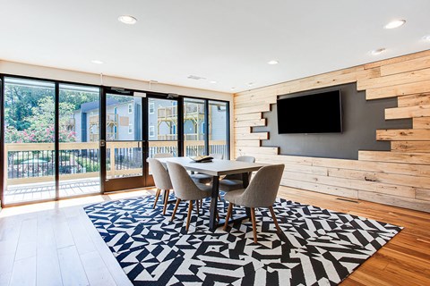 a dining room with a table and chairs and a television