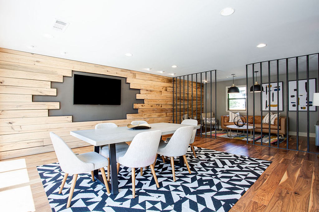a dining room with a white table and chairs