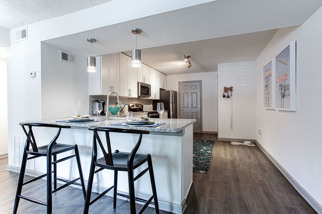 a kitchen with a bar and stools