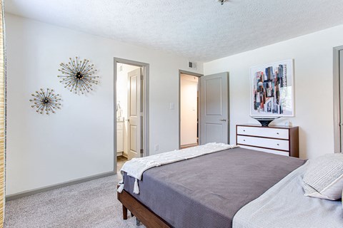 a bedroom with a bed and a dresser