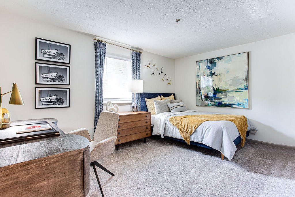 a bedroom with a bed and a desk