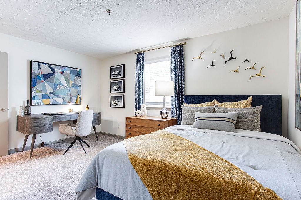 a bedroom with a bed and a desk