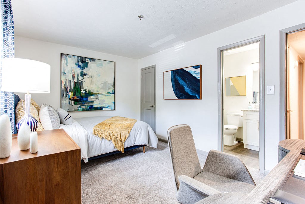 a bedroom with a bed and a bathroom