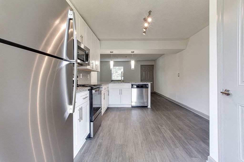 a kitchen with stainless steel appliances and white cabinets