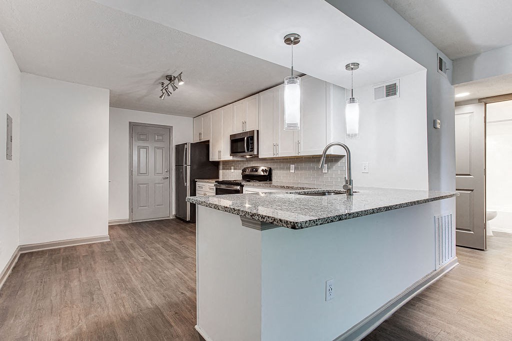 a kitchen with a counter top and a sink