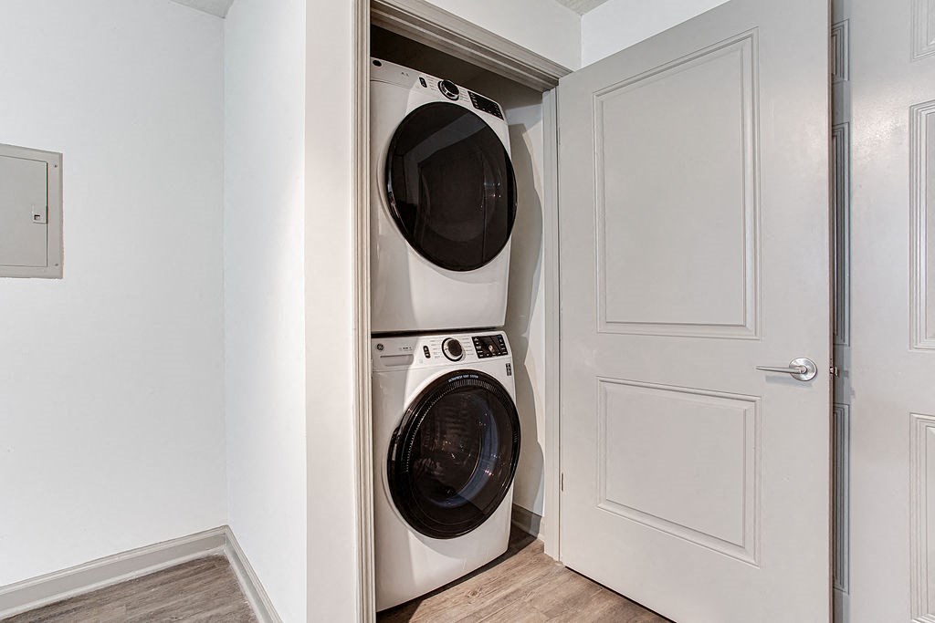 a small washer and dryer in a laundry room with a door