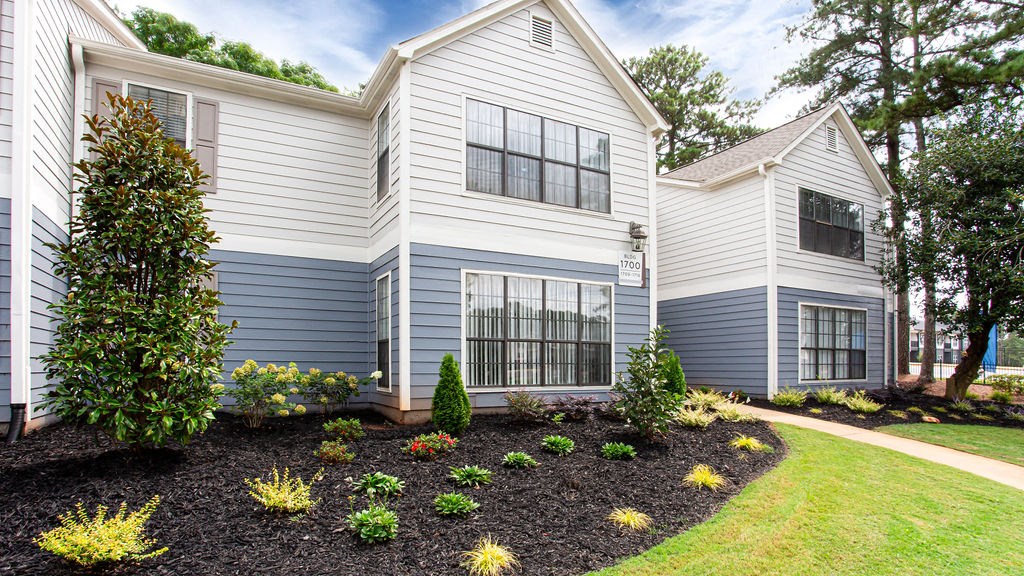the front of a house with a landscaped yard at Magnolia Place at Stockbridge Apartments, Stockbridge