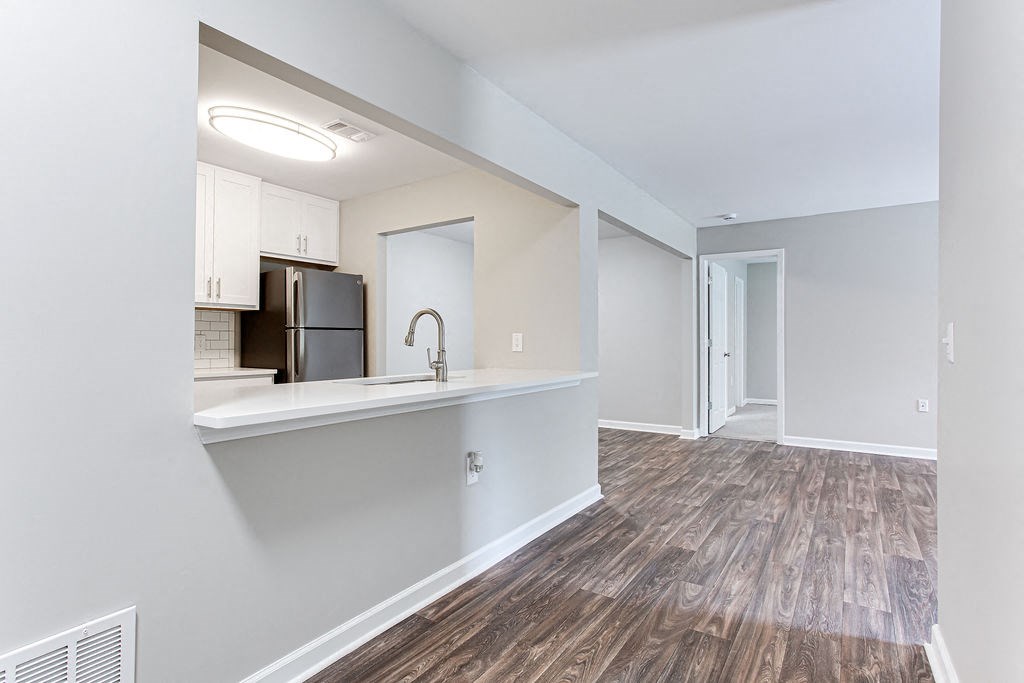 a renovated apartment with a kitchen and a living room at Magnolia Place at Stockbridge Apartments, Stockbridge, 30281