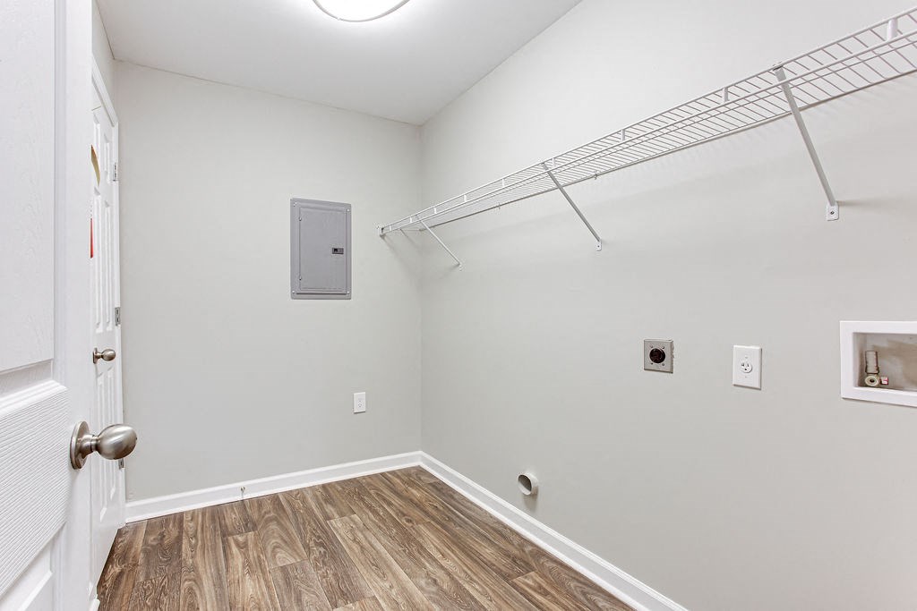 an empty room with a closet and a door to a bathroom at Magnolia Place at Stockbridge Apartments, Georgia