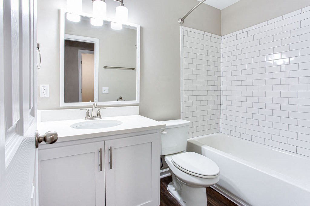 a white bathroom with a sink and a toilet at Magnolia Place at Stockbridge Apartments, Stockbridge, GA, 30281