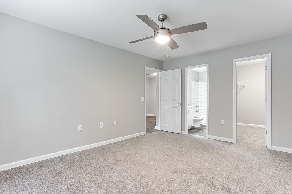 an empty living room with a ceiling fan and light at Magnolia Place at Stockbridge Apartments, Stockbridge, 30281