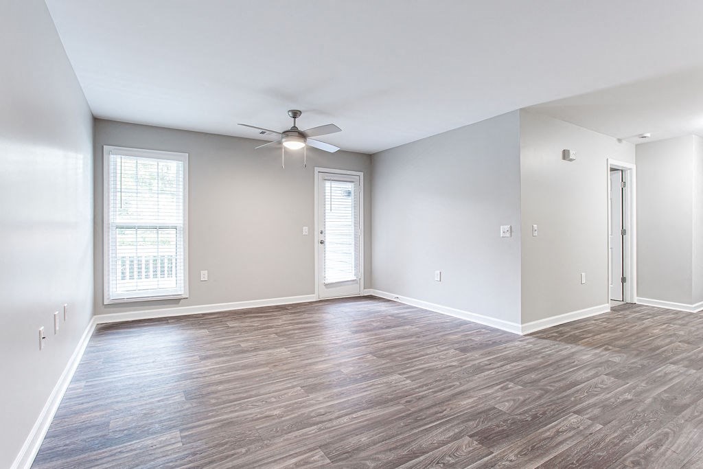 an empty living room with a ceiling fan and window at Magnolia Place at Stockbridge Apartments, Georgia, 30281