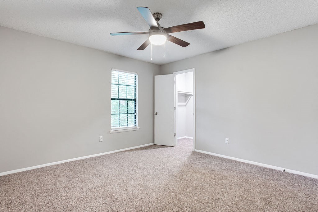 an empty living room with a ceiling fan at Magnolia Place at Stockbridge Apartments, Stockbridge, GA, 30281