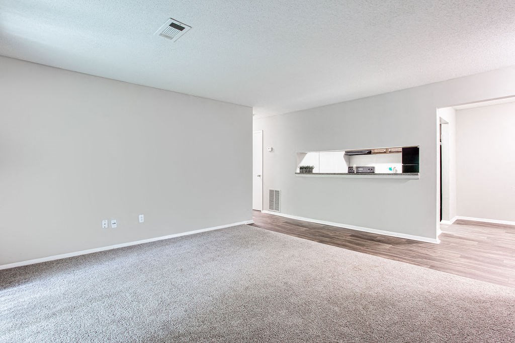 an empty living room with wood flooring and white walls at Magnolia Place at Stockbridge Apartments, Georgia, 30281