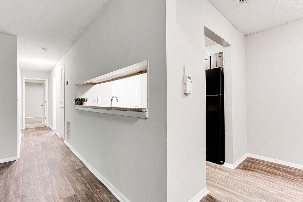a hallway with a sink and a mirror in a house at Magnolia Place at Stockbridge Apartments, Stockbridge