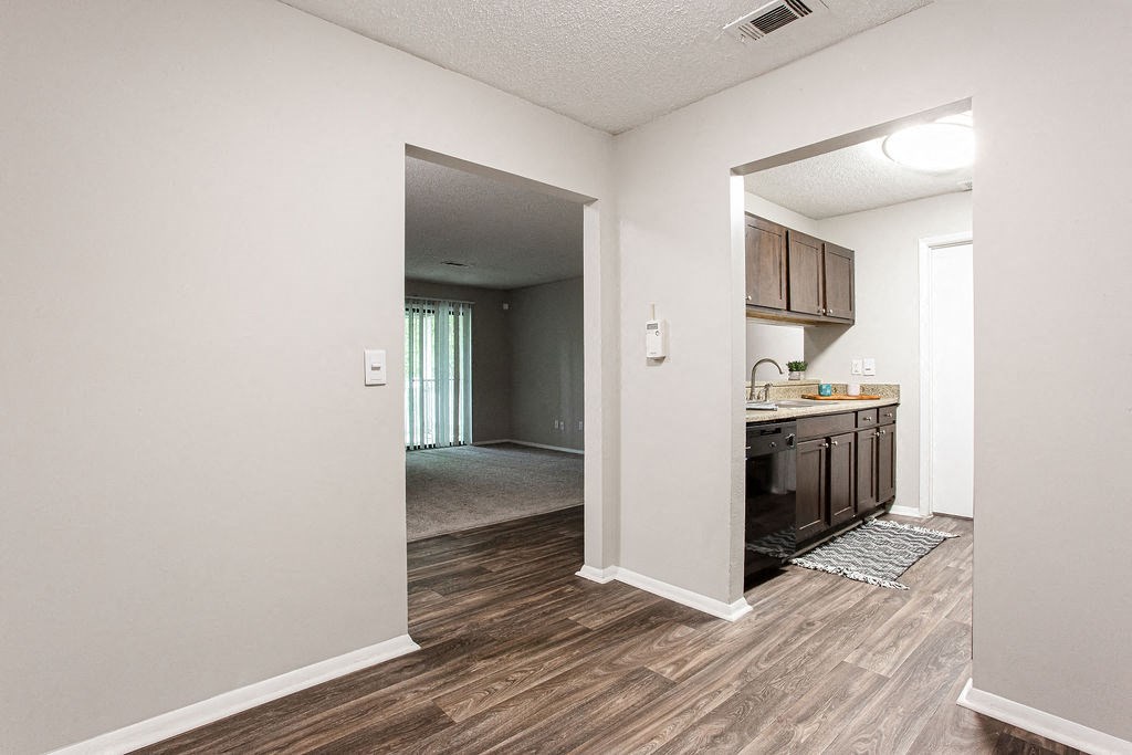 an open kitchen and living room with a door to a hallway at Magnolia Place at Stockbridge Apartments, Georgia